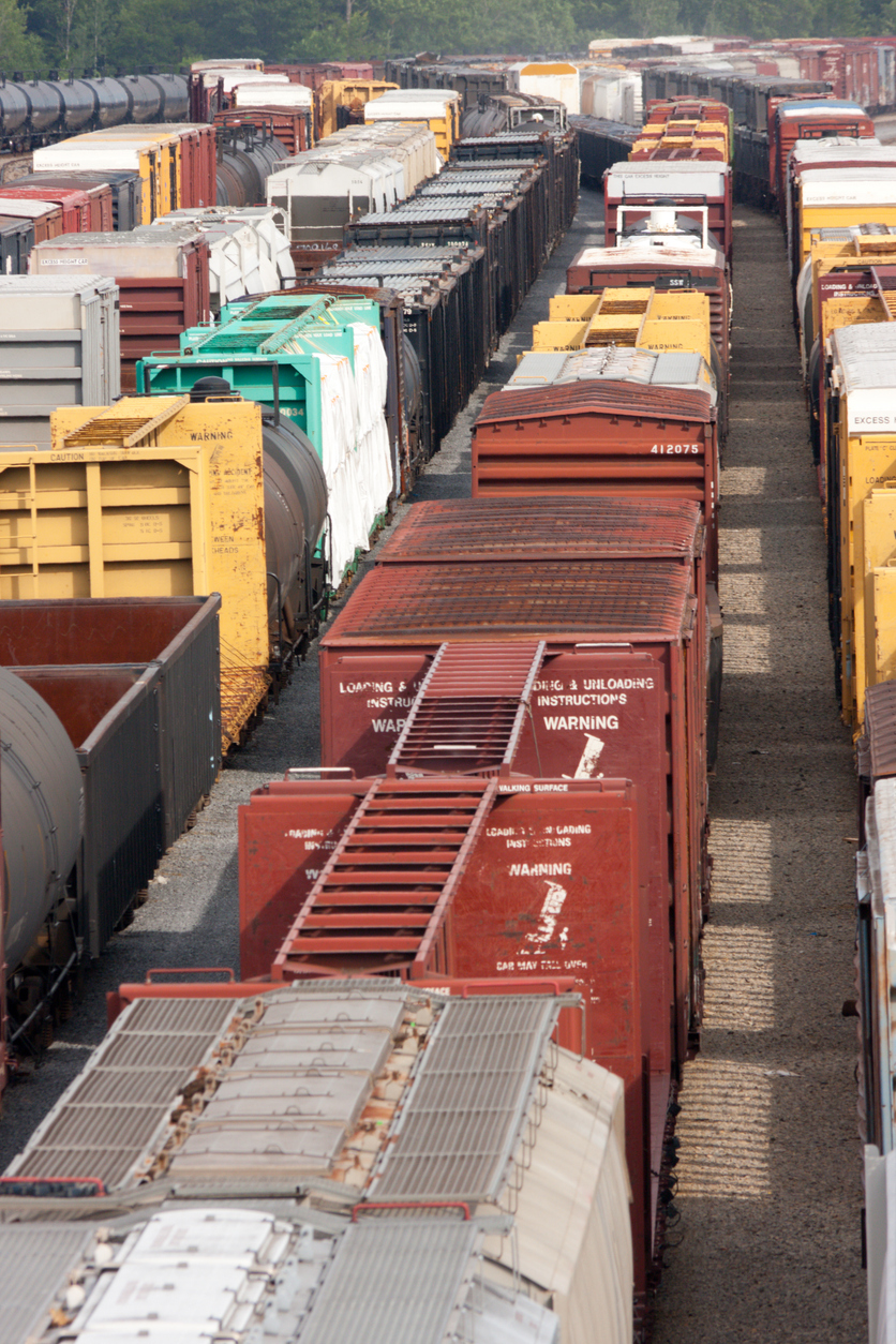 Several freight trains in a large rail yard waiting to depart